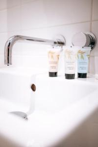 a bathroom sink with two bottles of moisturizers on it at Beach Bolthole 2 in Bournemouth