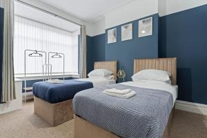 Postel nebo postele na pokoji v ubytování Sapphire Stadium Nest