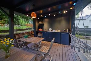 a patio with a table and chairs and a kitchen at "Parko vila" Anykščiai in Anykščiai