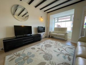 a living room with a flat screen tv and a couch at Fabulous Family Home in Lovely Little Stoke in Bristol