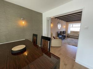 a living room with a table and a couch at Fabulous Family Home in Lovely Little Stoke in Bristol