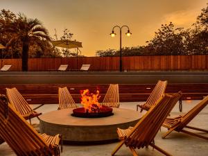 a fire pit in a patio with chairs around it at ANDO HOTEL NARA Wakakusayama -DLIGHT LIFE & HOTELS- in Nara