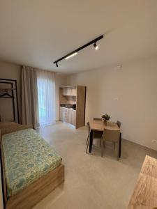 a bedroom with a bed and a table in it at Giglio di Mare Apartments in Rossano