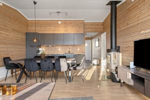 a kitchen and dining room with a table and chairs at Voss Resort self-catered apartments in Skulestadmo