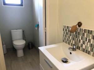 a bathroom with a white sink and a toilet at maison de famille in Driencourt +10 photos