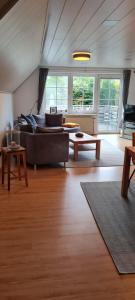 a living room with a couch and a table at Ferienwohnung mit Dachterrasse in Eicklingen