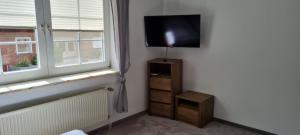 a room with a television on a wall next to a window at Ferienwohnung mit Dachterrasse in Eicklingen