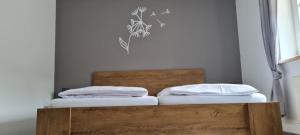 a bed with two pillows on top of it at Ferienwohnung mit Dachterrasse in Eicklingen