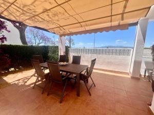 a wooden table and chairs on a patio at Condado de Alhama, NARANJOS 8 SV25 in El Romero