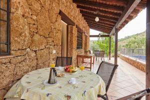 a table with food and drinks on a patio at Alojamiento Rural La Ventilla in Arbuniel