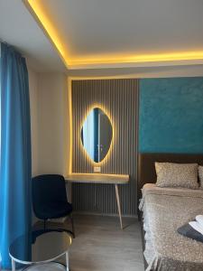 a bedroom with a bed and a mirror on the wall at Square Vanilla Apartments in Skopje