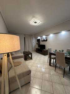 a living room with a couch and a table at Piraeus Seaside Apartment Escape in Piraeus