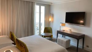 Un ou plusieurs lits dans un hébergement de l'établissement Hôtel Le Canberra