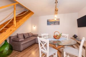 a living room with a table and a couch at Mirna Luka in Punat