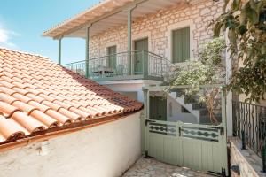 a house with a balcony and a roof at Teacher's House in Meganisi