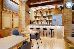 a restaurant with tables and chairs and a bar at Ad Hoc Monumental 1881 in Valencia