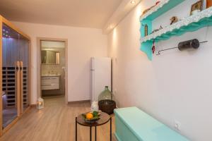 a living room with a blue couch and a refrigerator at Mirna Luka in Punat +34 photos