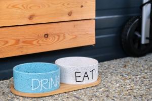 two cups sitting on a counter with the words drink and eat at Mobile Home Ella in Sveti Petar +25 photos