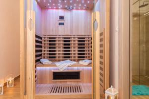 a walk in shower in a room with a glass door at Mirna Luka in Punat