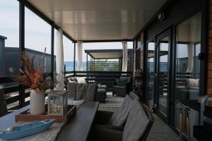 a living room with a table and chairs on a balcony at Mobile Home Ella in Sveti Petar