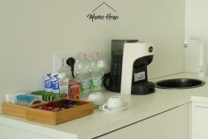 a kitchen counter with a coffee maker and bottles of milk at Mama House Cenisio in Milan