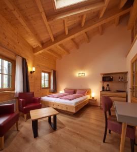 a bedroom with a bed and a table and chairs at Carolinger Hüttendorf in Weyer +148 photos
