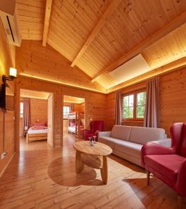 a living room with a couch and a table at Carolinger Hüttendorf in Weyer