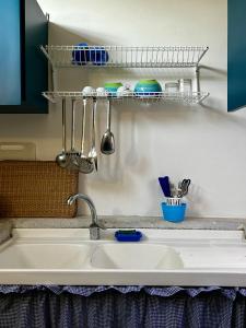 a kitchen sink with a shelf above it at Capitolo in Monopoli