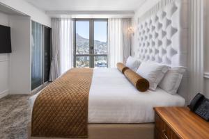 a bedroom with a large bed with a large window at Pepperclub Hotel in Cape Town +44 photos