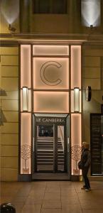 a woman standing in front of a store door at Hôtel Le Canberra in Cannes