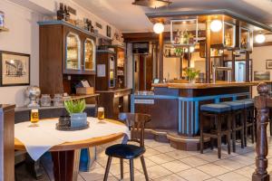 a restaurant with tables and chairs and a bar at Haus Fliederbusch in Borken