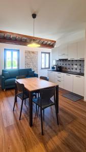 a living room with a table and a blue couch at Civico134 in Sirolo