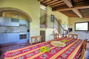 a kitchen with a table with a plate on it at Villa Ulivi by PosarelliVillas in Lucignano