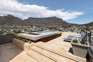 a house with a swimming pool on a roof with mountains at Pepperclub Hotel in Cape Town