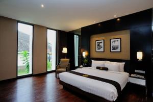 a large bedroom with a large bed and windows at Java Heritage Hotel Purwokerto in Purwokerto +27 photos