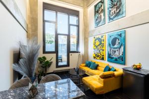 a living room with a yellow couch and a table at Ventiri Lofts - Kalamata Luxury Penthouses in Faraí