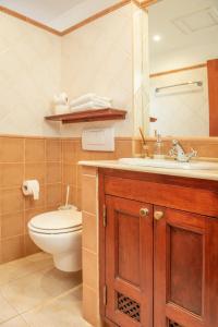 a bathroom with a toilet and a sink at Surfescape Fuerteventura in Lajares