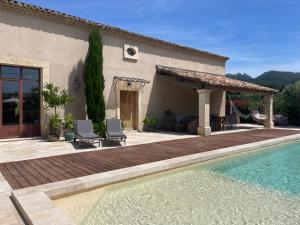 a house with a swimming pool in front of a house at Côté Dentelles in Vacqueyras