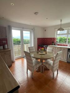 a kitchen with a table and chairs in a room at Cozy seaside cottage in Wexford