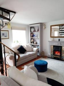 a living room with a couch and a fireplace at Cozy seaside cottage in Wexford