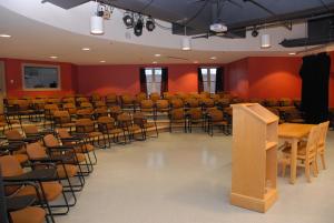 a lecture hall with chairs and tables and a podium at University of King's College in Halifax