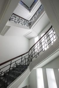 a spiral staircase in a building with windows at Radisson Blu 1919 Hotel, Reykjavík in Reykjavík