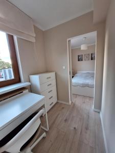 a bedroom with a bed and a dresser and a mirror at Apartament 3 in Drawsko Pomorskie