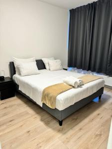 a bedroom with a large bed with black curtains at Cosy Apartment in the Hague! in The Hague +1 photo