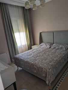 a bedroom with a bed and a window at Dar soufia in Nabeul