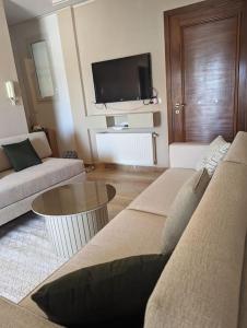 a living room with a couch and a table at Dar soufia in Nabeul