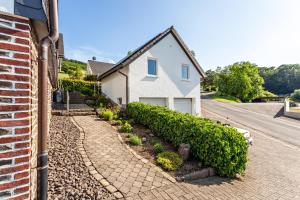 a house on a street with a cobblestone driveway at Ferienhaus Am Brande in Schmallenberg