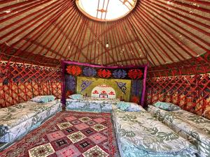 a room with two beds in a yurt at Yurt camp Chyrak in Tong