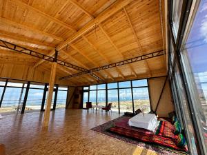 a room with a bed in a room with windows at Yurt camp Chyrak in Tong