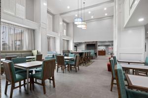 un comedor con mesas y sillas y una cafetería en Hampton Inn & Suites Mount Pleasant en Mount Pleasant